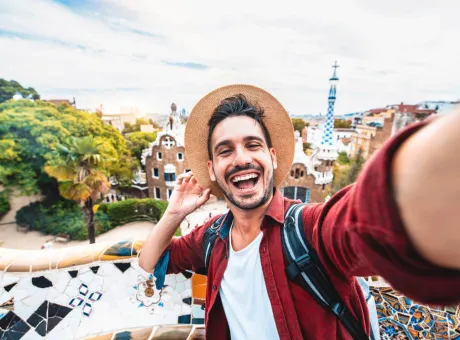 happy tourist take selfie selfportrait with smartphone park guell barcelona spain