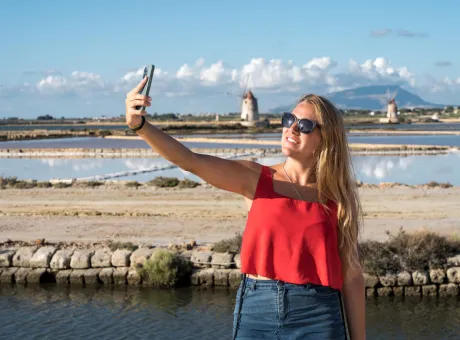 tourist taking selfie salt flats marsala sicily italy