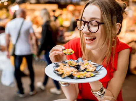 young woman red dress having lunch with mussels rose wine sitting food market 1