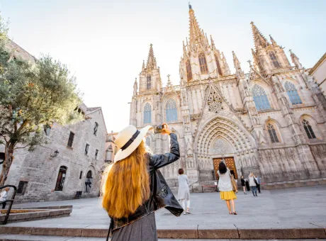 young woman tourist photographing with phone famous saint eulalia church during morning light barcelona city 1